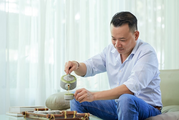 Man drinking tea at home