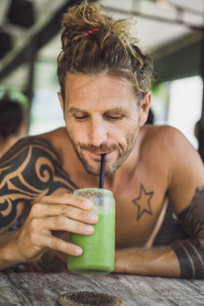 man drinks healthy smoothies