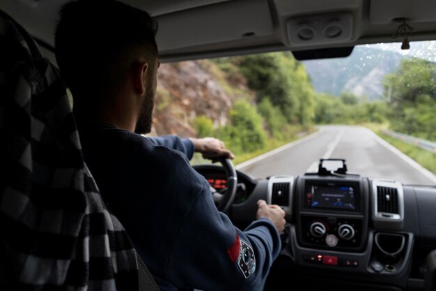 Man driving his camper for a new trip