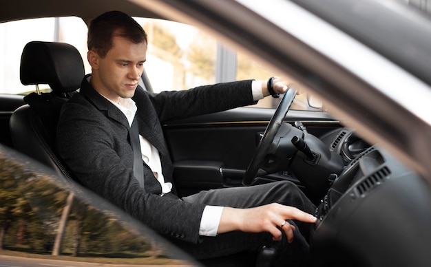 Man driving his elegant car for taxi services