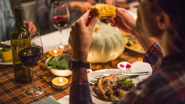 Man eating corn at table