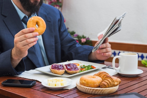 Man eating donut in restaurant