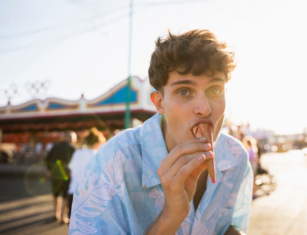 Man eating ice cream while looking at camera