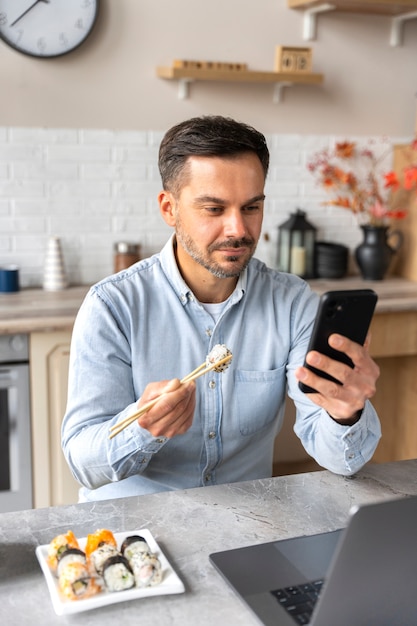 無料写真 寿司を食べながらミディアムショットをする男性