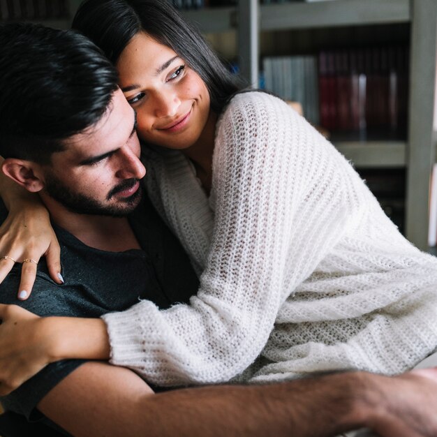 Man embracing her smiling girlfriend