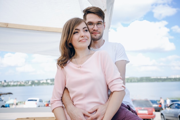 Man embracing his girlfriend from behind