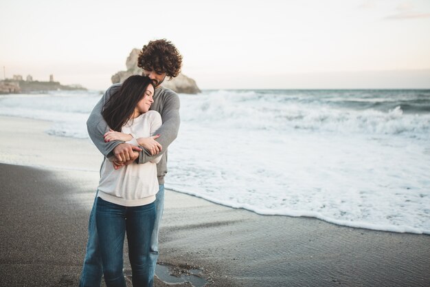 Man embracing his young girlfriend by the back