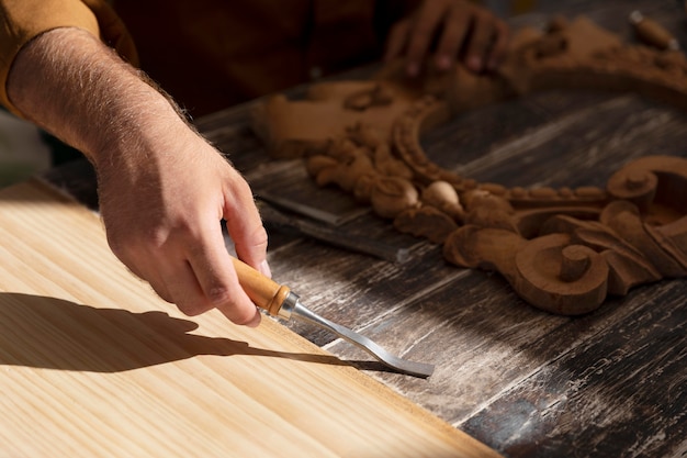 Free photo man engraving in wood outdoors