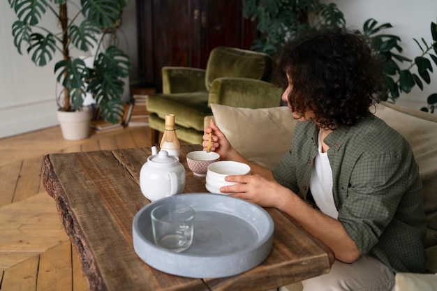 Free photo man enjoying a cup of matcha tea