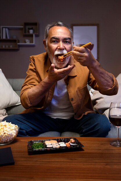 Man enjoying his home alone time with some sushi