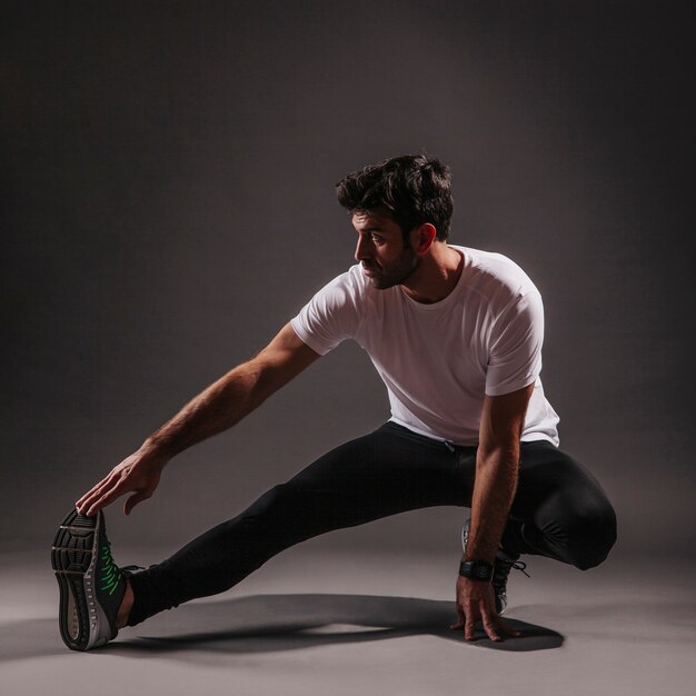 Man exercising on dark background