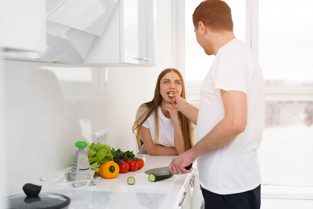 Man feeding woman