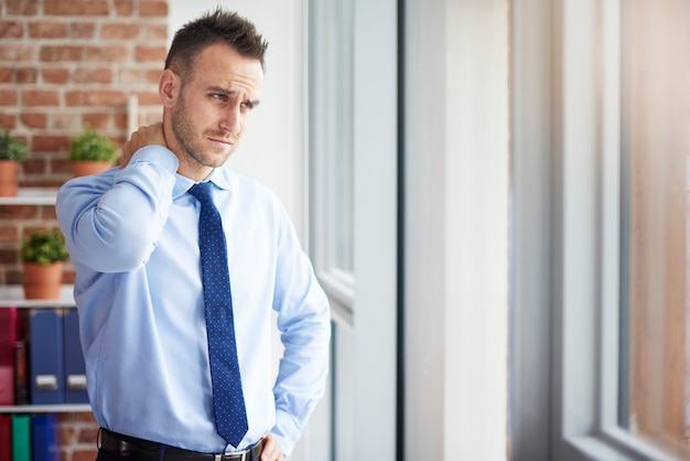 Man feeling pain in his neck