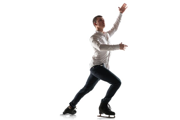 Man figure skating isolated on white studio wall with copyspace. Professional practicing and training in action and motion on ice. Graceful and weightless. Concept of movement, sport, beauty.