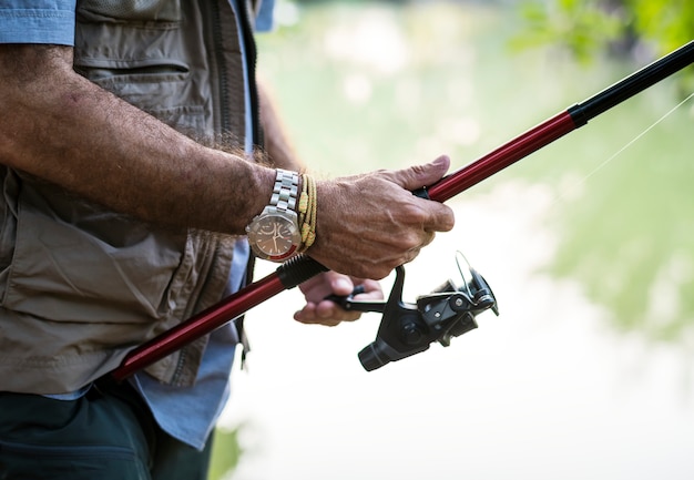 Free photo man fishing by a lake