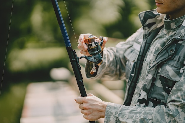 Man fishing and holds the angling rod