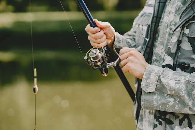 Man fishing and holds the angling rod