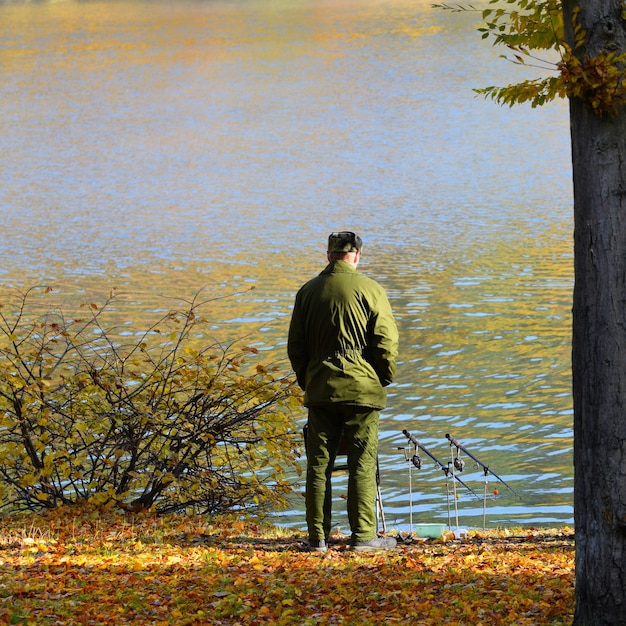 "Man fishing on lakeside"