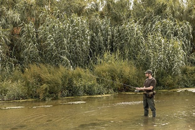 Free photo man fishing at the river