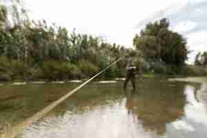 Free photo man fishing at the river