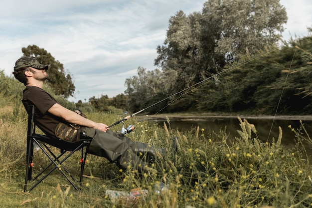 Free photo man fishing at the river