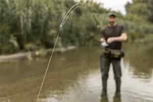 Free photo man fishing at the river