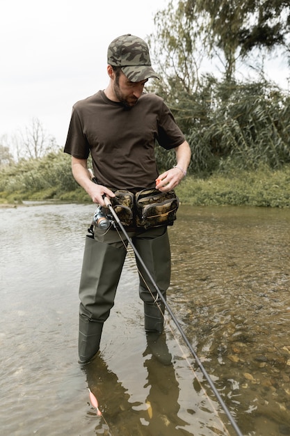 Free photo man fishing at the river