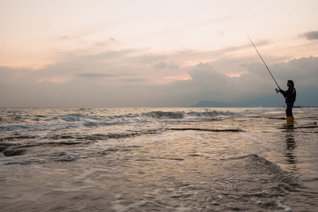 男は海岸で釣り