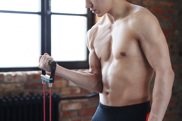 Man fitness workout. Shirtless man doing stretching at home