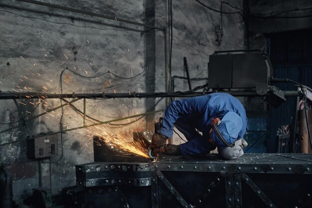 Man fitter working doing polishing metal