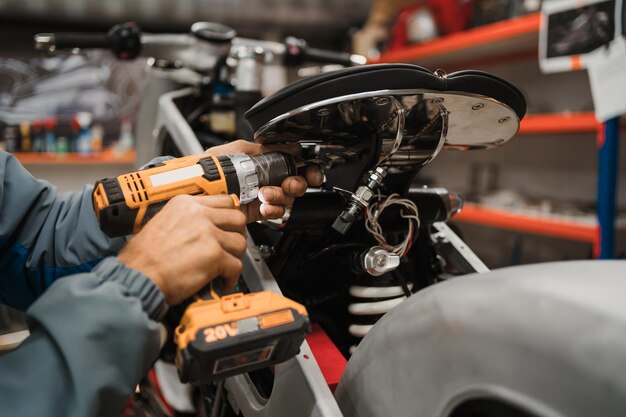 Man fixing a motorcycle in a modern workshop