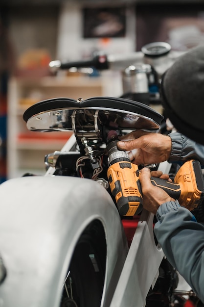 Man fixing a motorcycle in a modern workshop