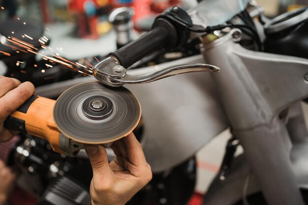 Man fixing a motorcycle in a modern workshop