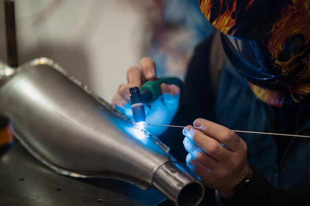 Man fixing a motorcycle in a modern workshop