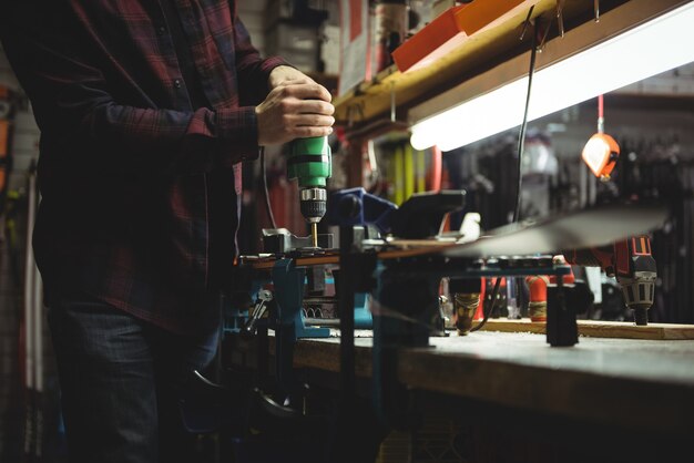 Man fixing ski binding on ski