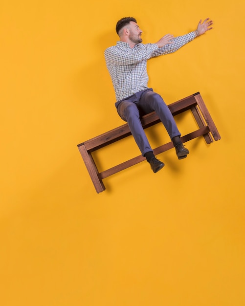 Free photo man floating on a bench