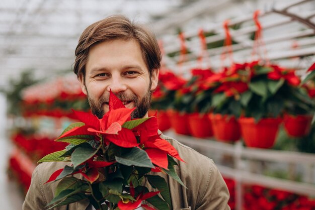 Man florist working in green house