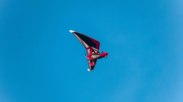 Man flying in motorized hang glider in Liverpool United Kingdom