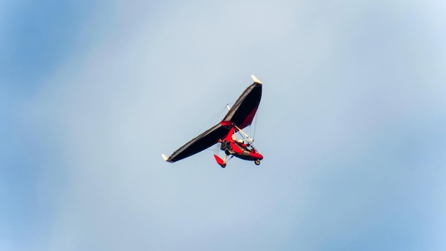 Man flying in motorized hang glider in Liverpool United Kingdom