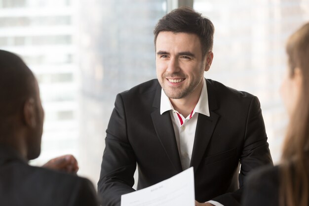 Man focusing on conversation with interviewers