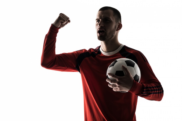 Free photo man football soccer player silhouette in studio isolated on white stands with a ball victory