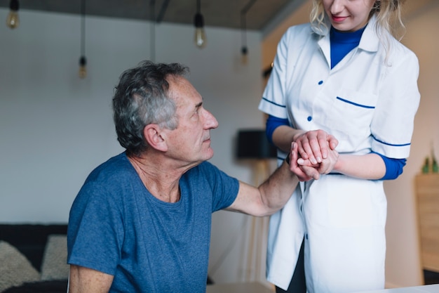 Man and friendly nurse in old age home