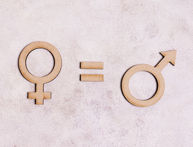 Man gender symbols equals female gender symbol on marble background