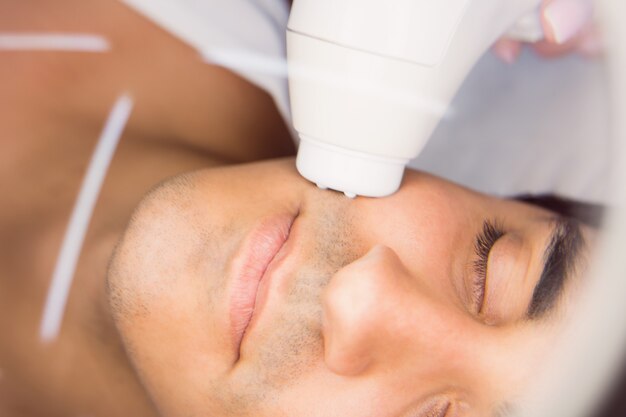 Man getting a facial massage at clinic