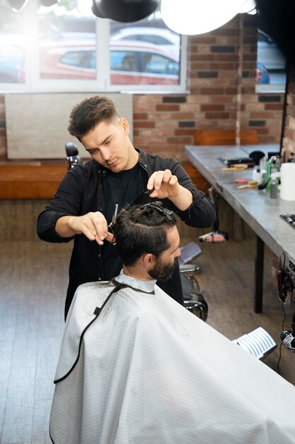 Man getting a haircut at salon medium shot