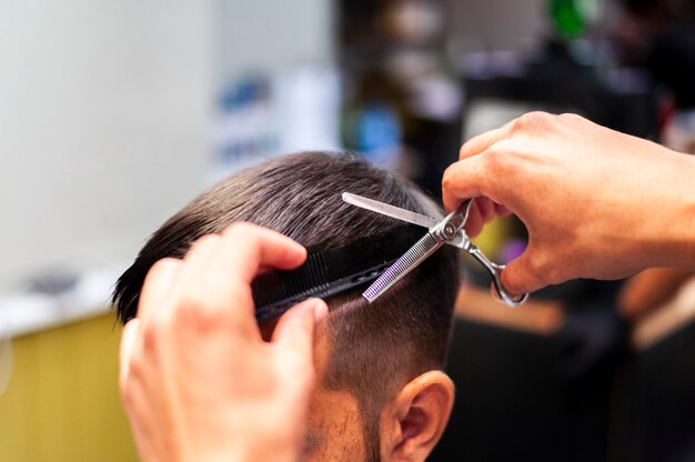 Man getting a haircut with scissors