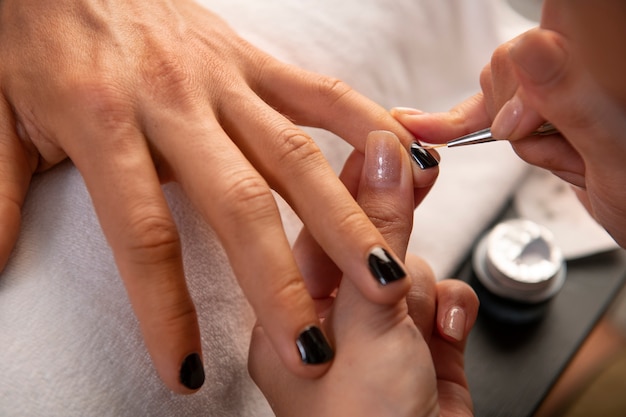 Free photo man getting a manicure high angle