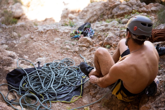 Free photo man getting ready to climb on a mountain