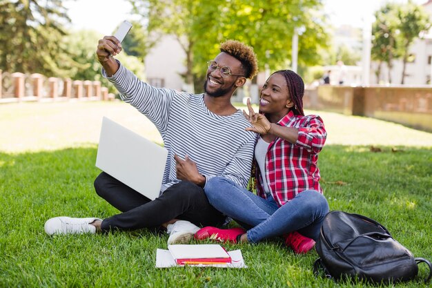 Man and girl taking selfie in park