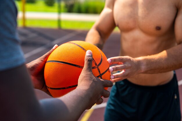 Man giving the ball to the other man